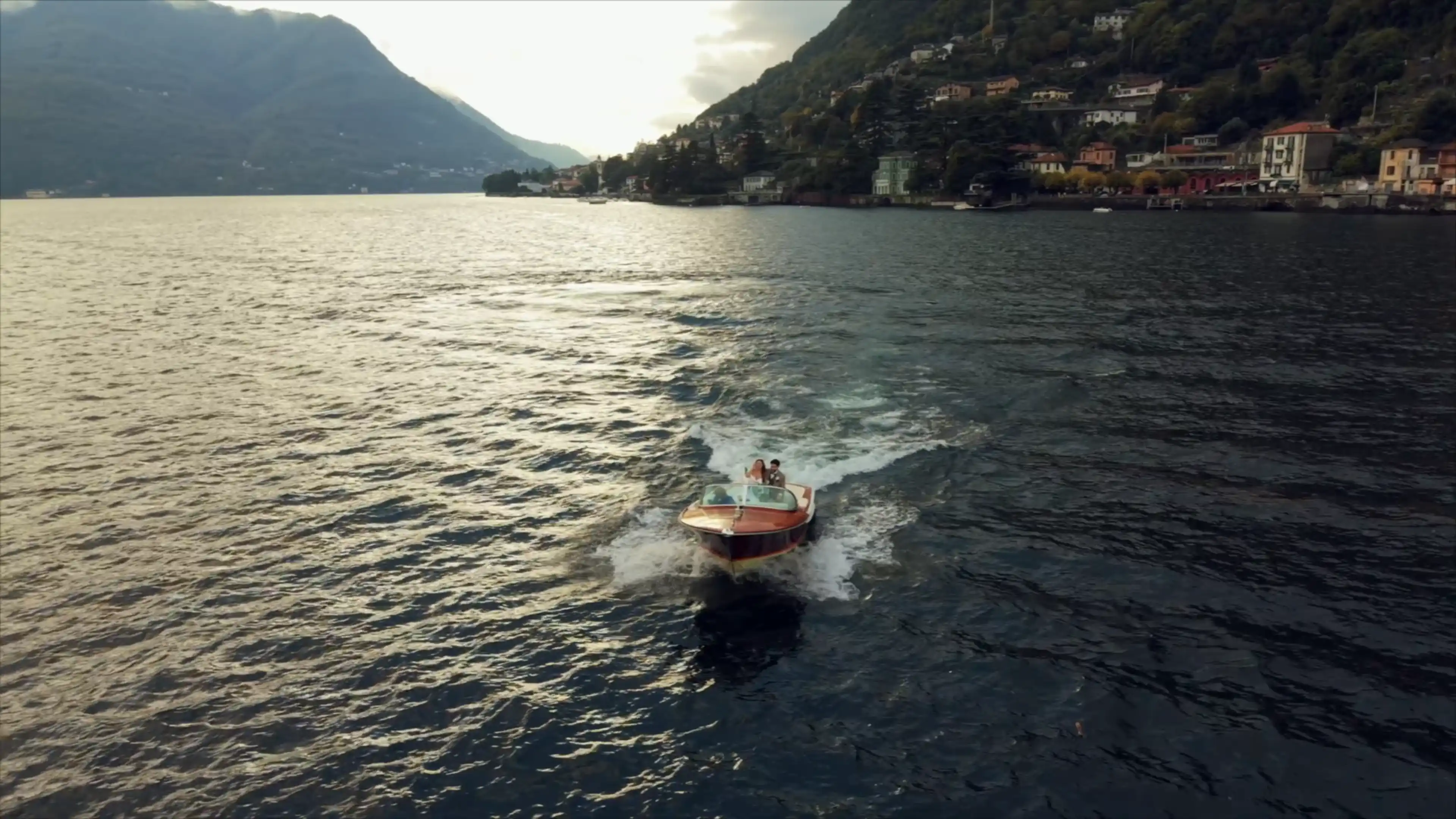 Riva boat on Lake Como at golden hour